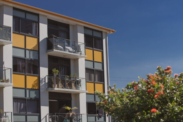 Diagram showing Queensland Home Warranty Insurance coverage for residential buildings up to three storeys within community titles schemes.