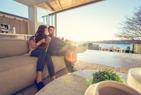 Couple relaxing in modern apartment protected by Developer Bond Scheme Victoria